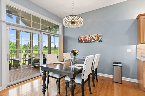 a view of a dining room with furniture wooden floor and a chandelier