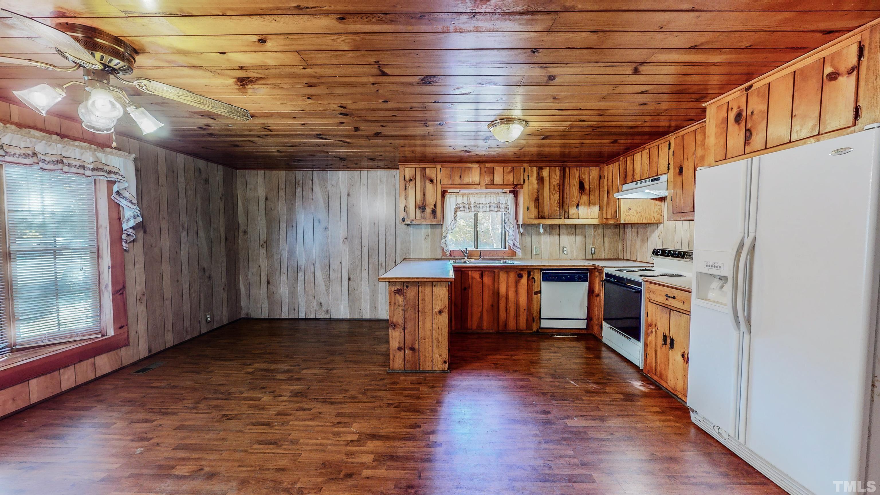 412 Shiloh Church Road Roxboro, NC 27574 - Photo 14 of 30 a kitchen with stainless steel appliances granite countertop a refrigerator a sink and wooden floors