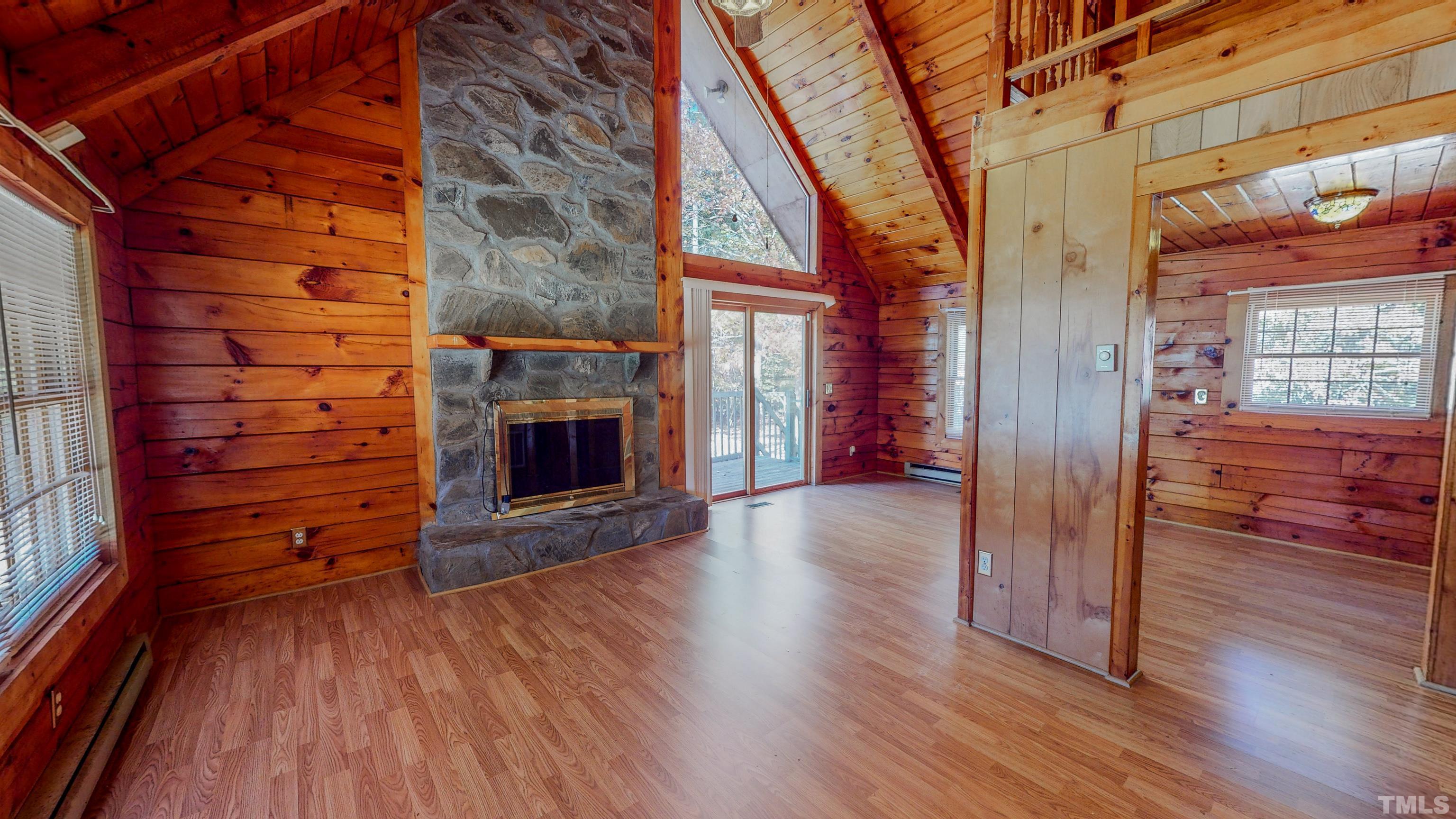 412 Shiloh Church Road Roxboro, NC 27574 - Photo 3 of 30 a view of a hallway with wooden floor and a fireplace