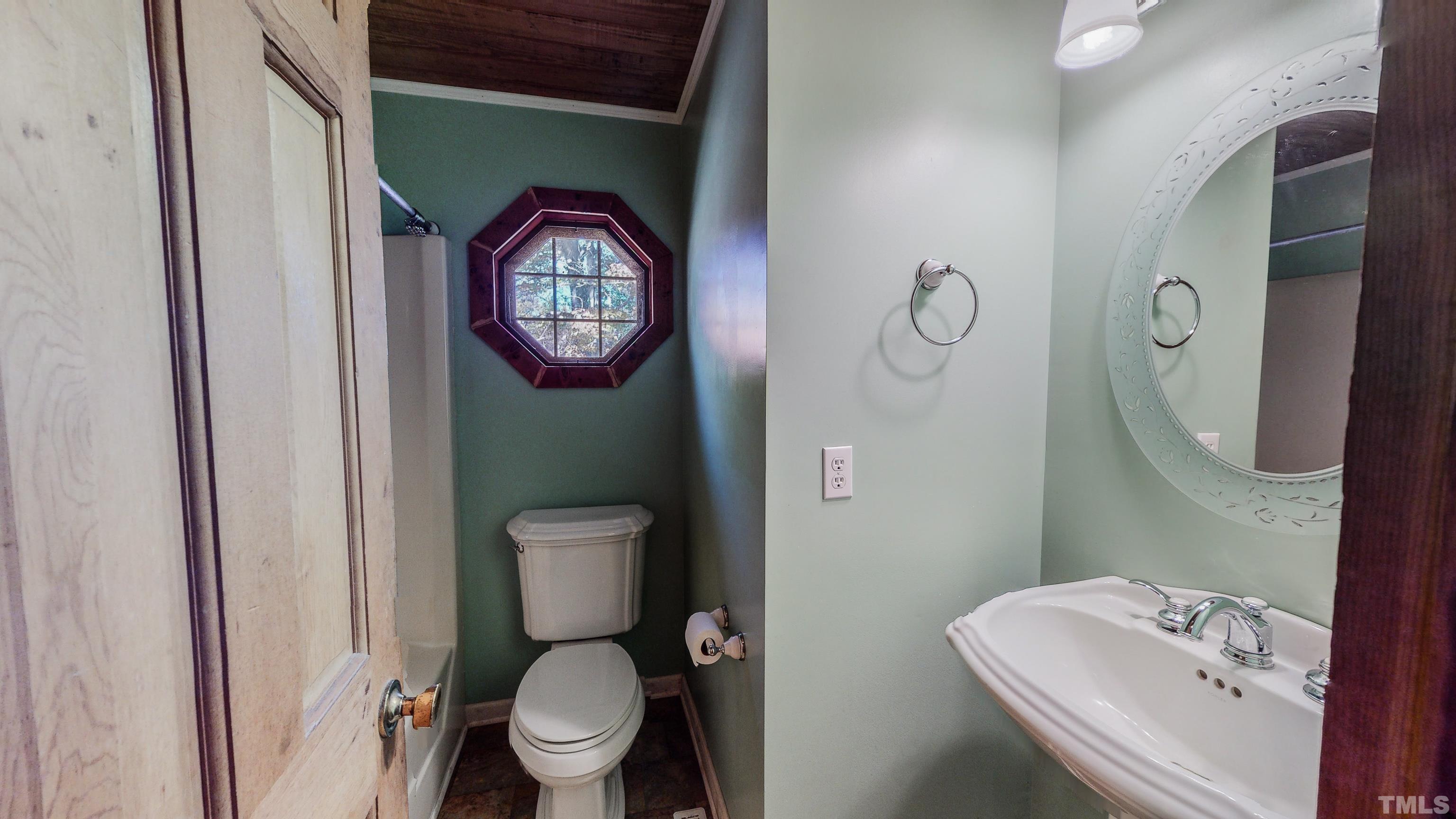 412 Shiloh Church Road Roxboro, NC 27574 - Photo 29 of 30 a bathroom with a toilet sink vanity and mirror