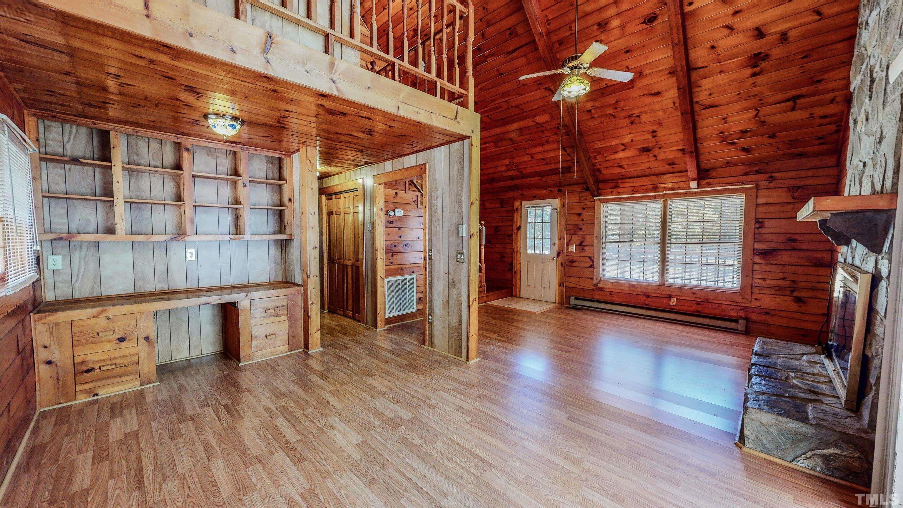 412 Shiloh Church Road Roxboro, NC 27574 - Photo 4 of 30 a view of an empty room with wooden floor and a window