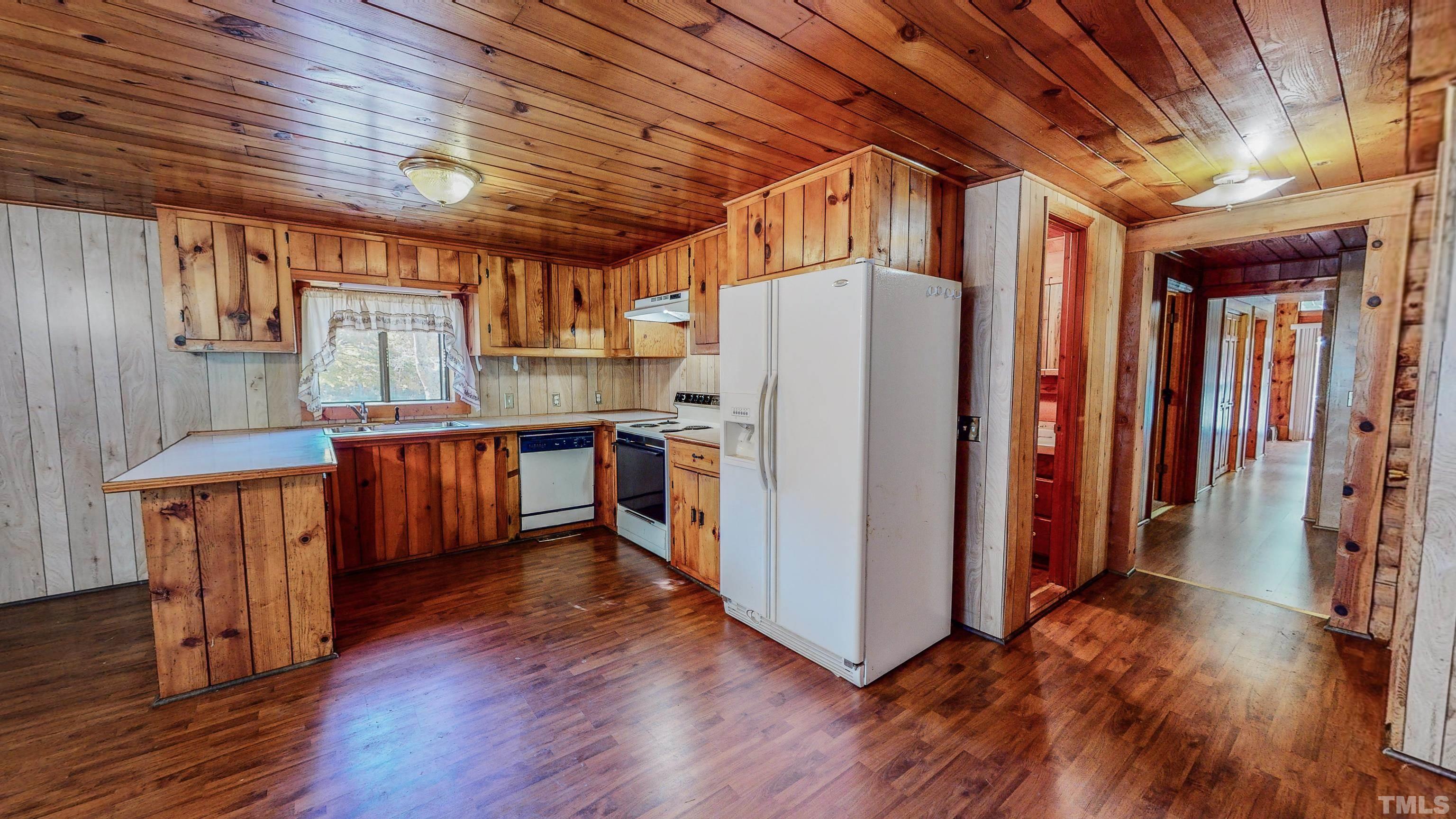 412 Shiloh Church Road Roxboro, NC 27574 - Photo 6 of 30 a kitchen with stainless steel appliances granite countertop a refrigerator a sink dishwasher a stove and white countertops with wooden floor