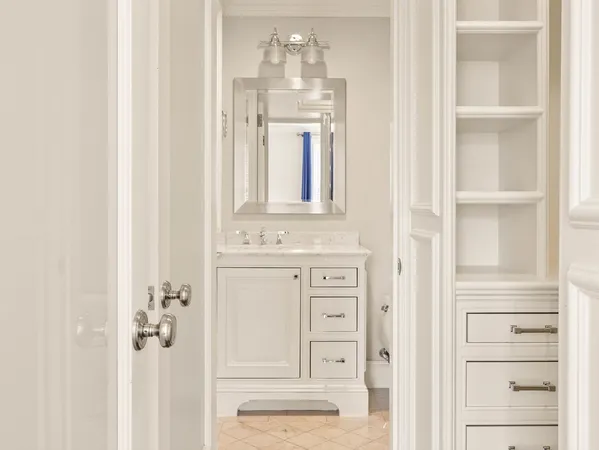 a bedroom with a bed lamp on table and a window