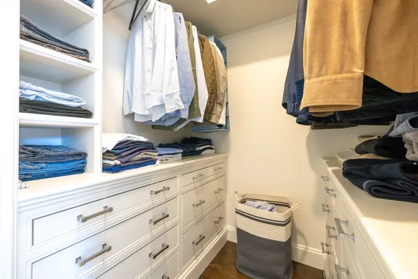 a bathroom with a toilet sink vanity and mirror