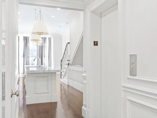 a kitchen with stainless steel appliances granite countertop a stove and white cabinets next to a window