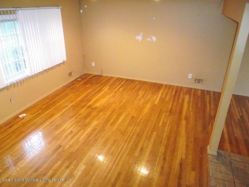1 Sarno Street Colonia, NJ 07067 - Photo 4 of 30 a view of an empty room with wooden floor and a window