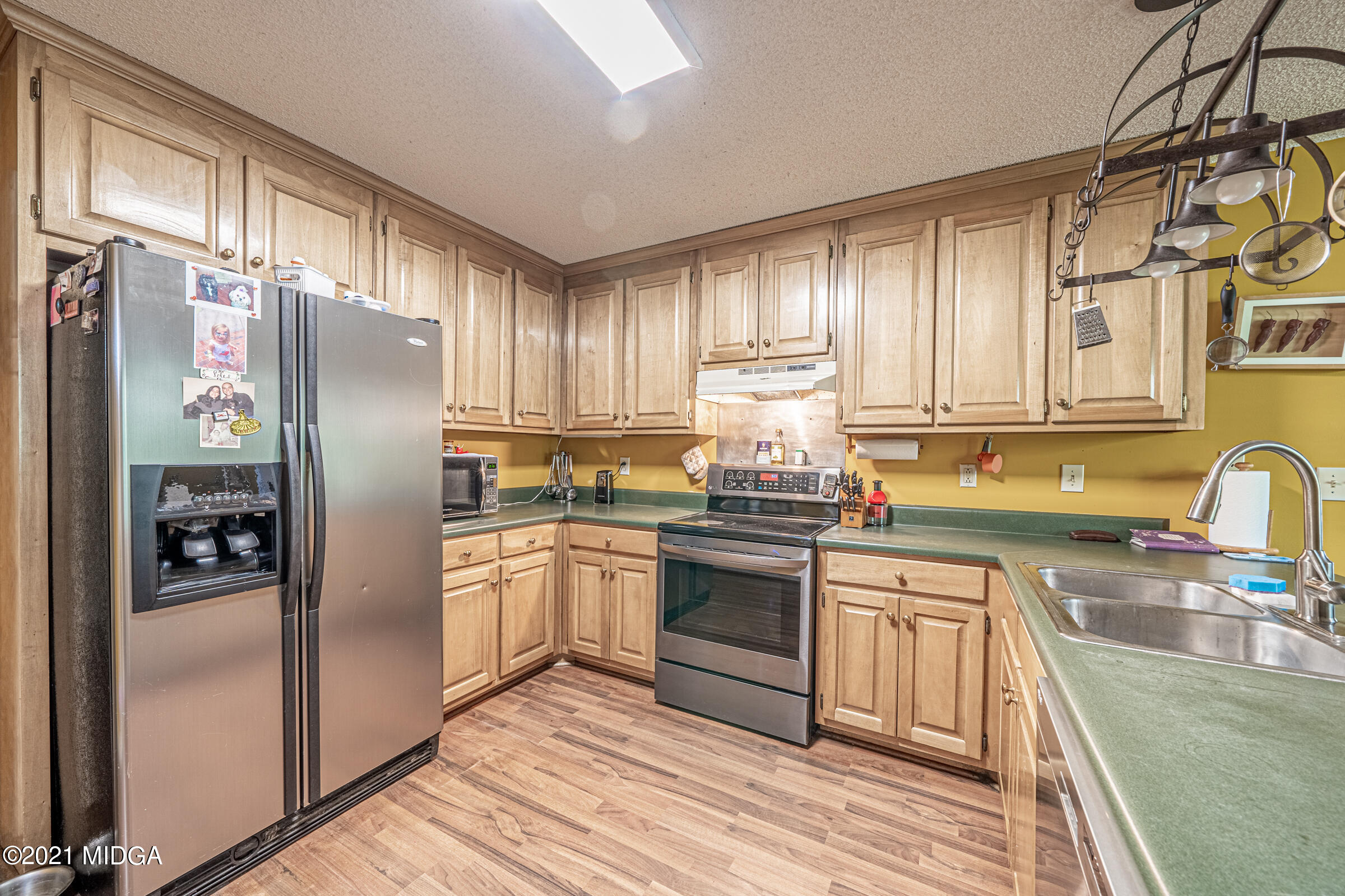 239 Plantation Road Gray, GA 31032 - Photo 12 of 28 a kitchen with stainless steel appliances granite countertop a refrigerator sink and cabinets
