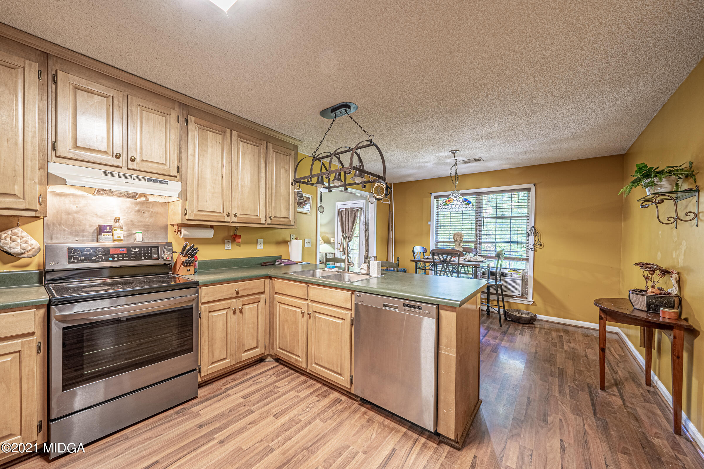 239 Plantation Road Gray, GA 31032 - Photo 13 of 28 a kitchen with stainless steel appliances granite countertop a stove and cabinets