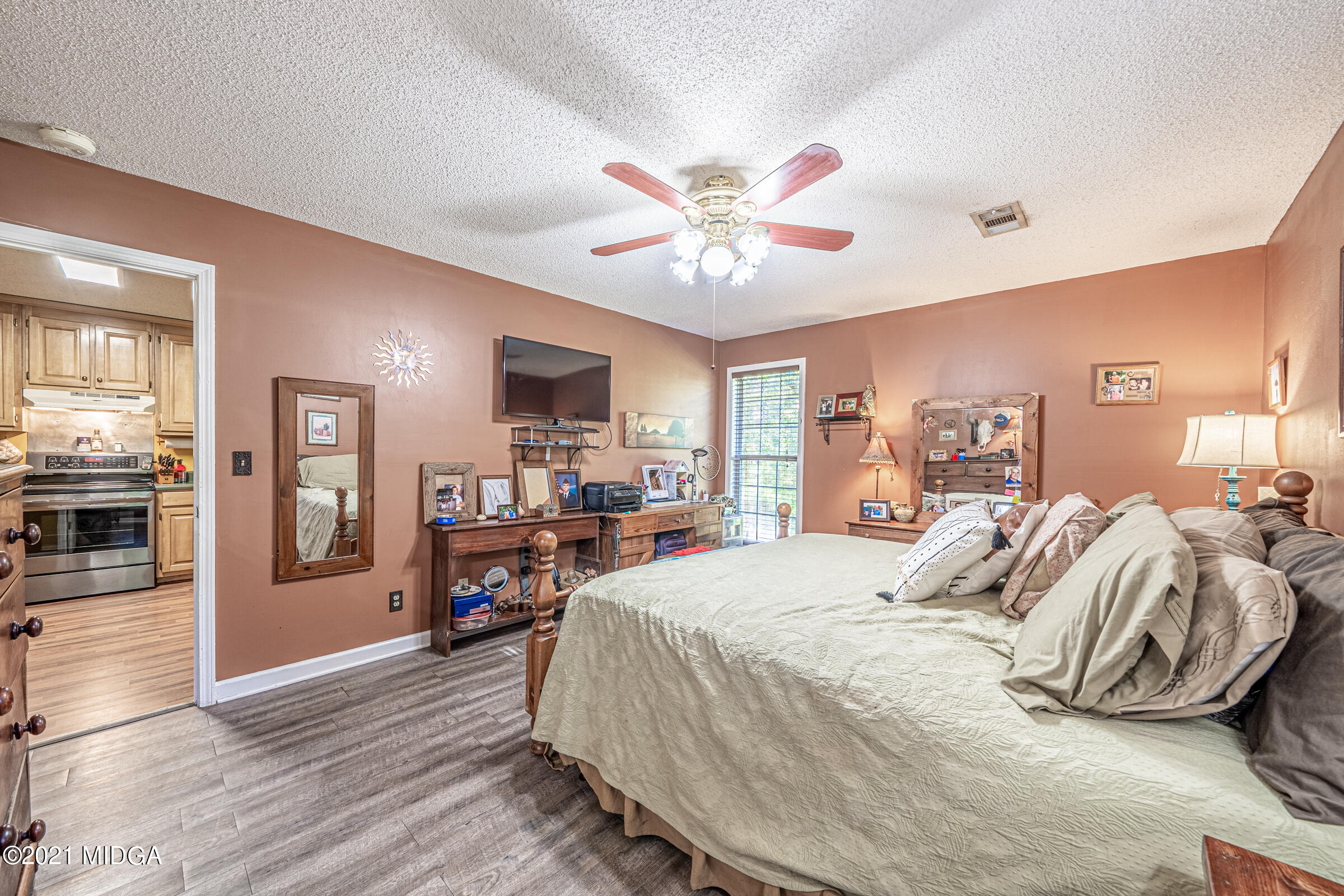 239 Plantation Road Gray, GA 31032 - Photo 15 of 28 a bedroom with a bed and wooden floor