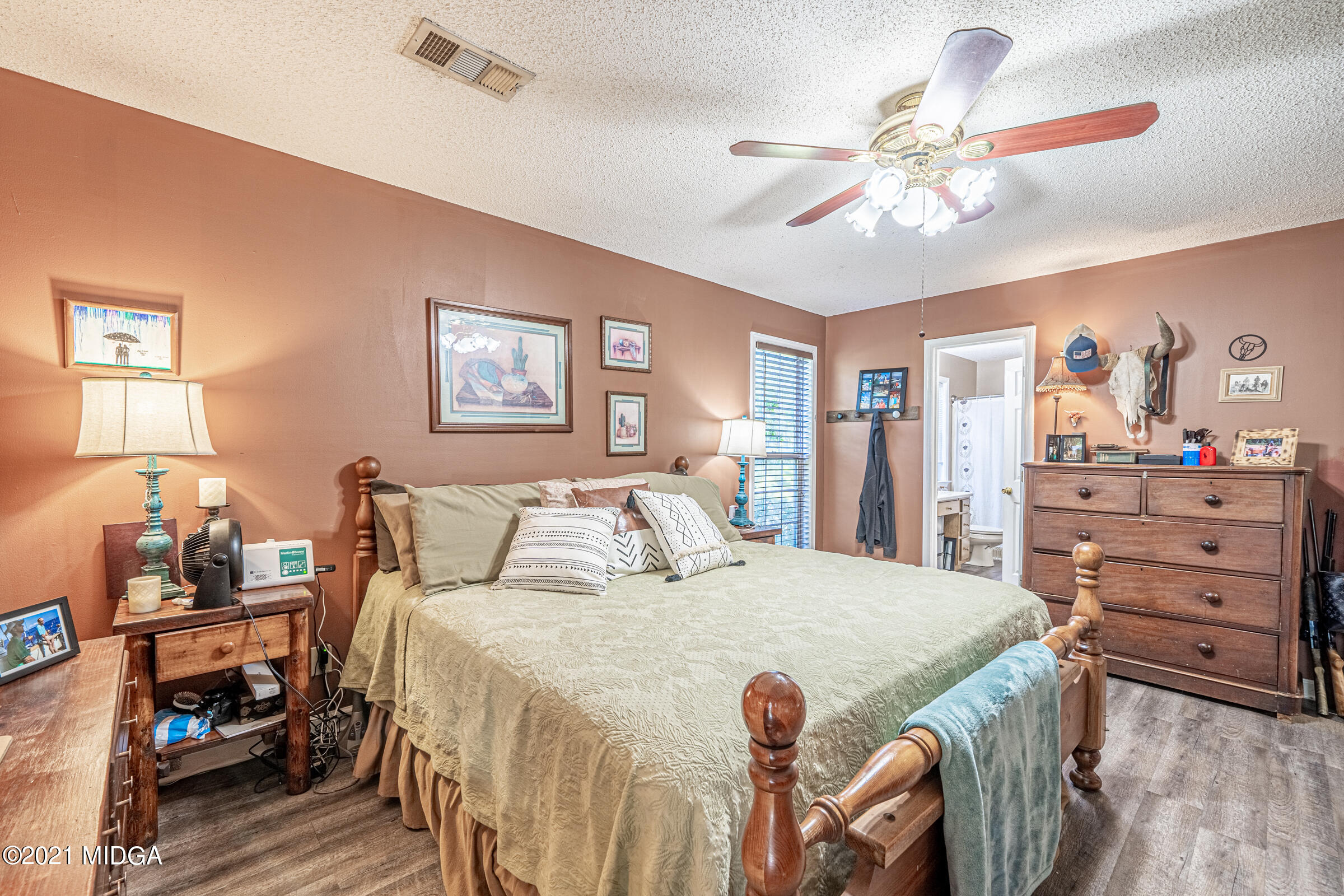 239 Plantation Road Gray, GA 31032 - Photo 16 of 28 a bedroom with a bed and a chandelier