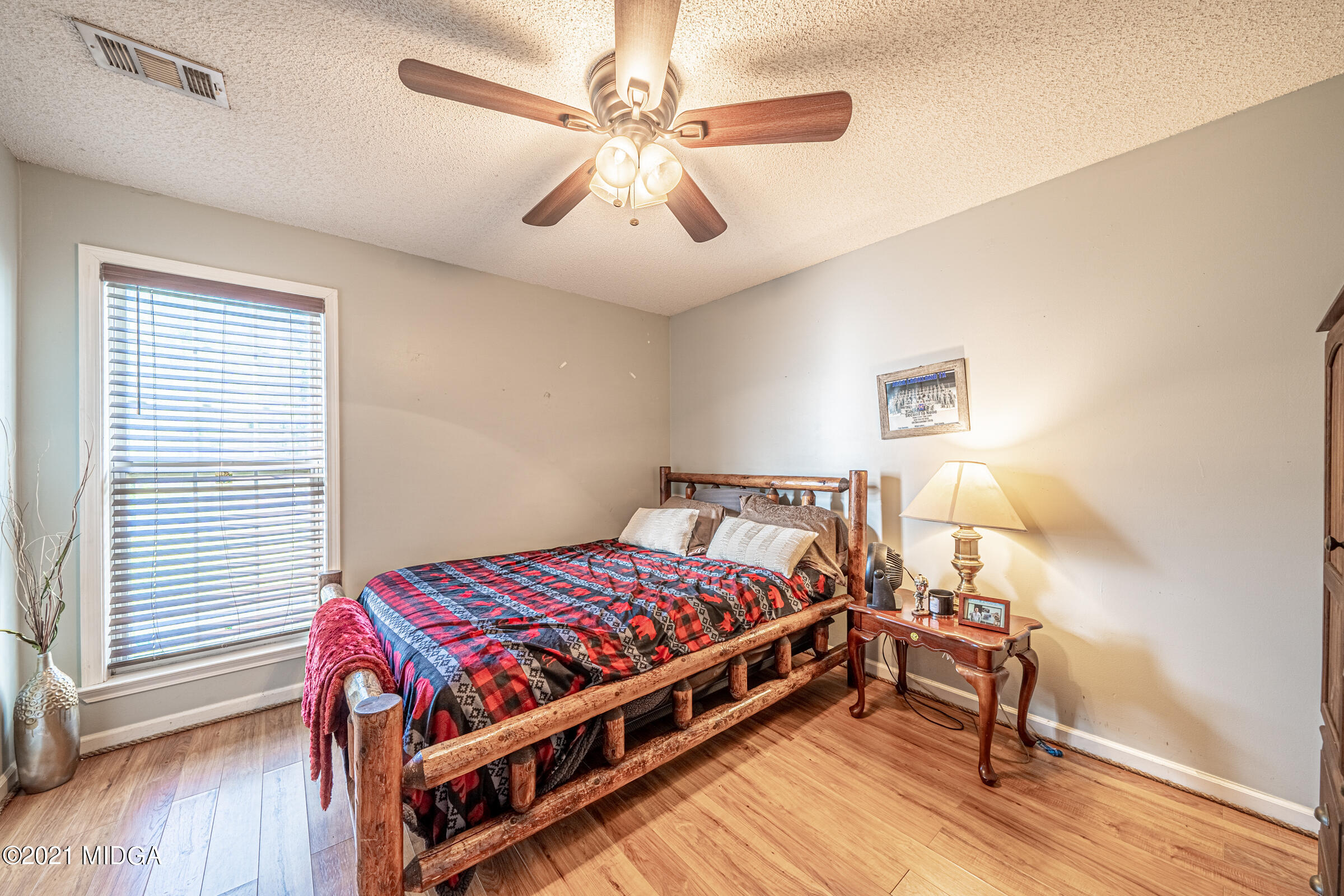 239 Plantation Road Gray, GA 31032 - Photo 19 of 28 a bedroom with a bed and a chandelier