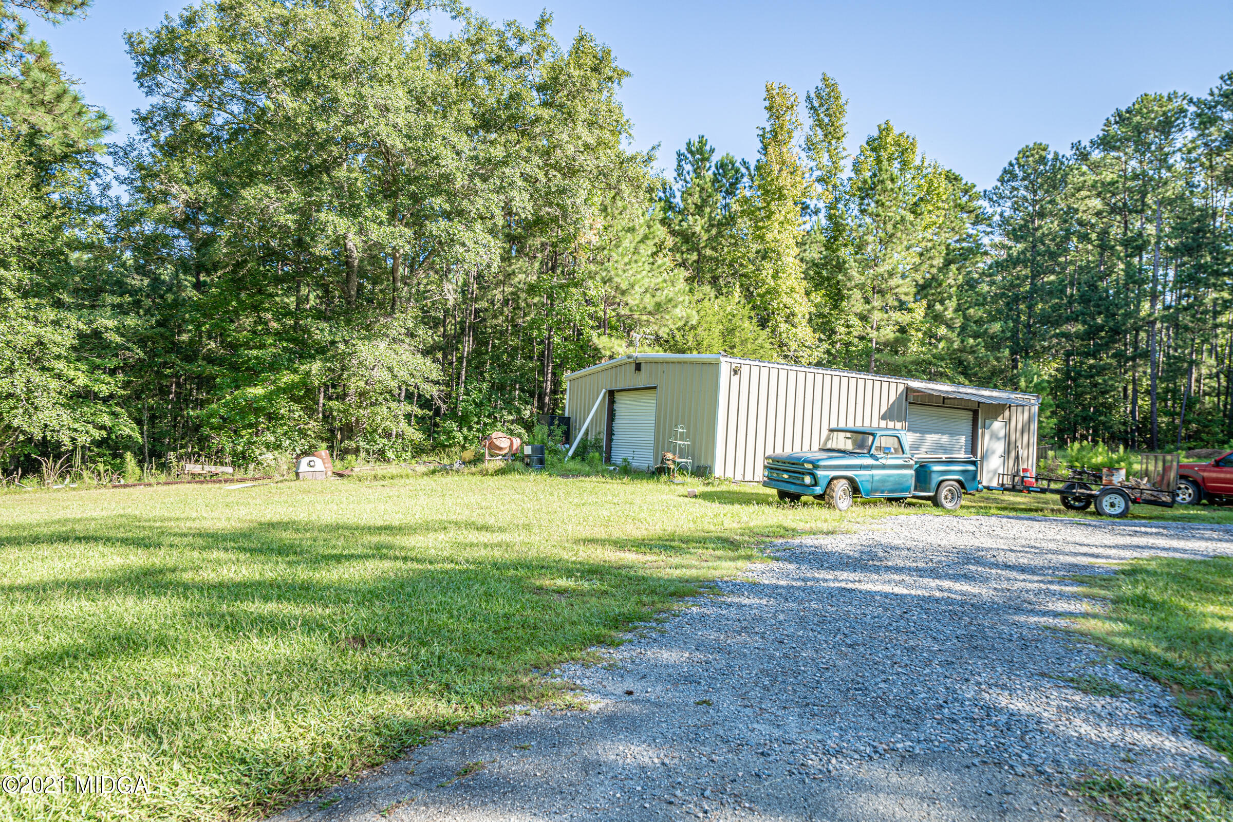 239 Plantation Road Gray, GA 31032 - Photo 26 of 28 a house view with a big yard and large trees