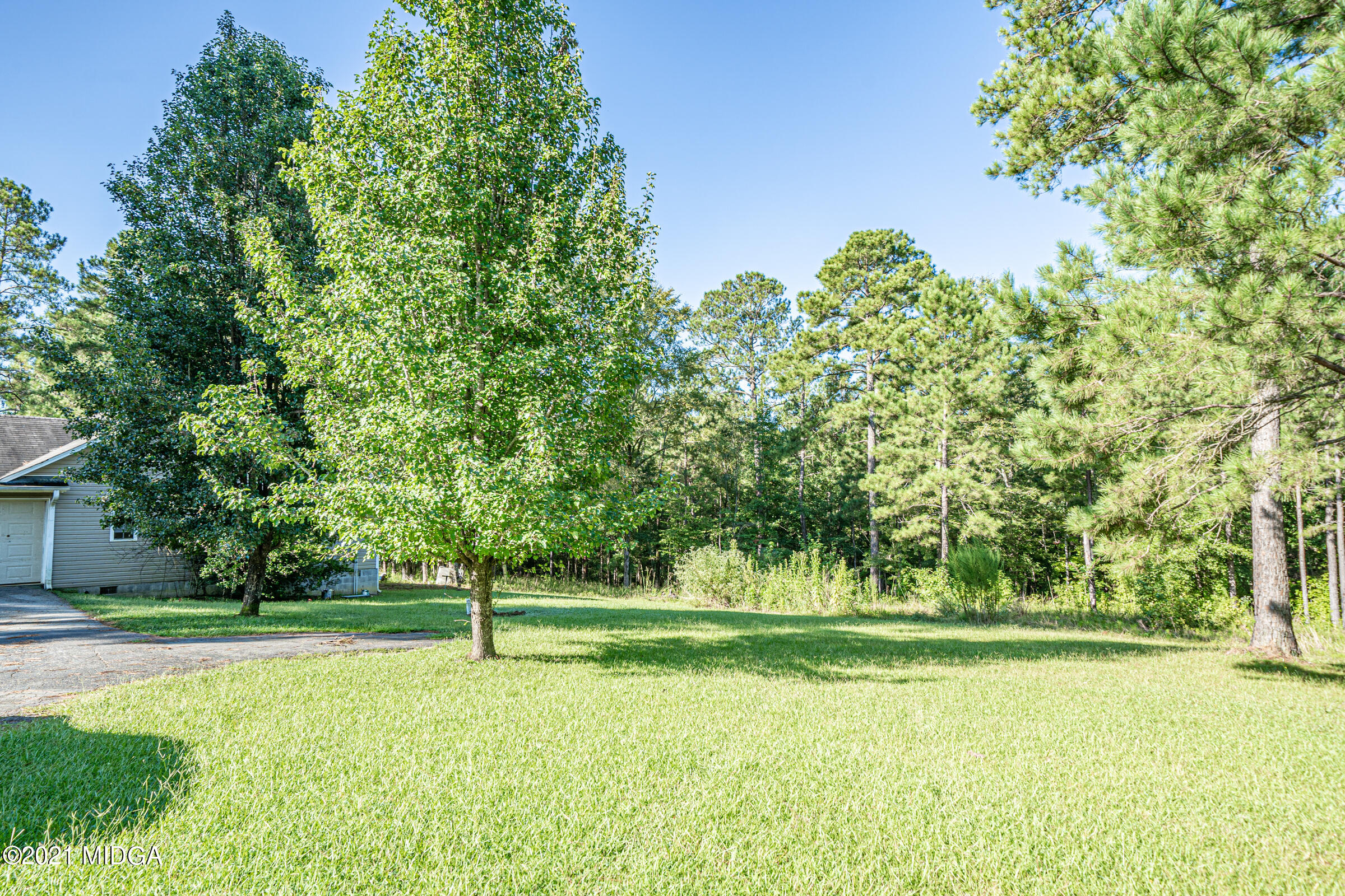 239 Plantation Road Gray, GA 31032 - Photo 27 of 28 a view of a golf course with a trees