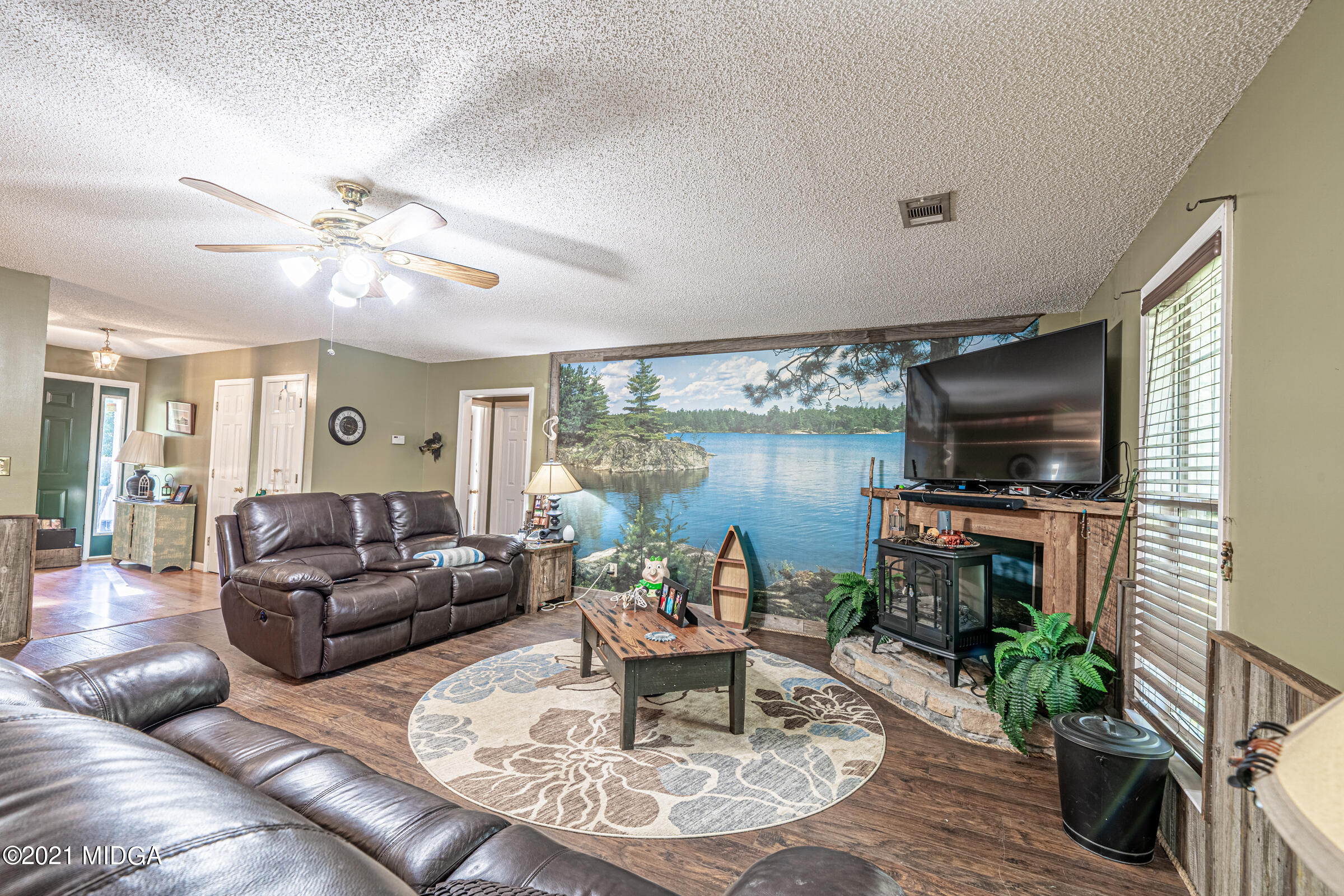 239 Plantation Road Gray, GA 31032 - Photo 6 of 28 a living room with furniture a flat screen tv and a fireplace