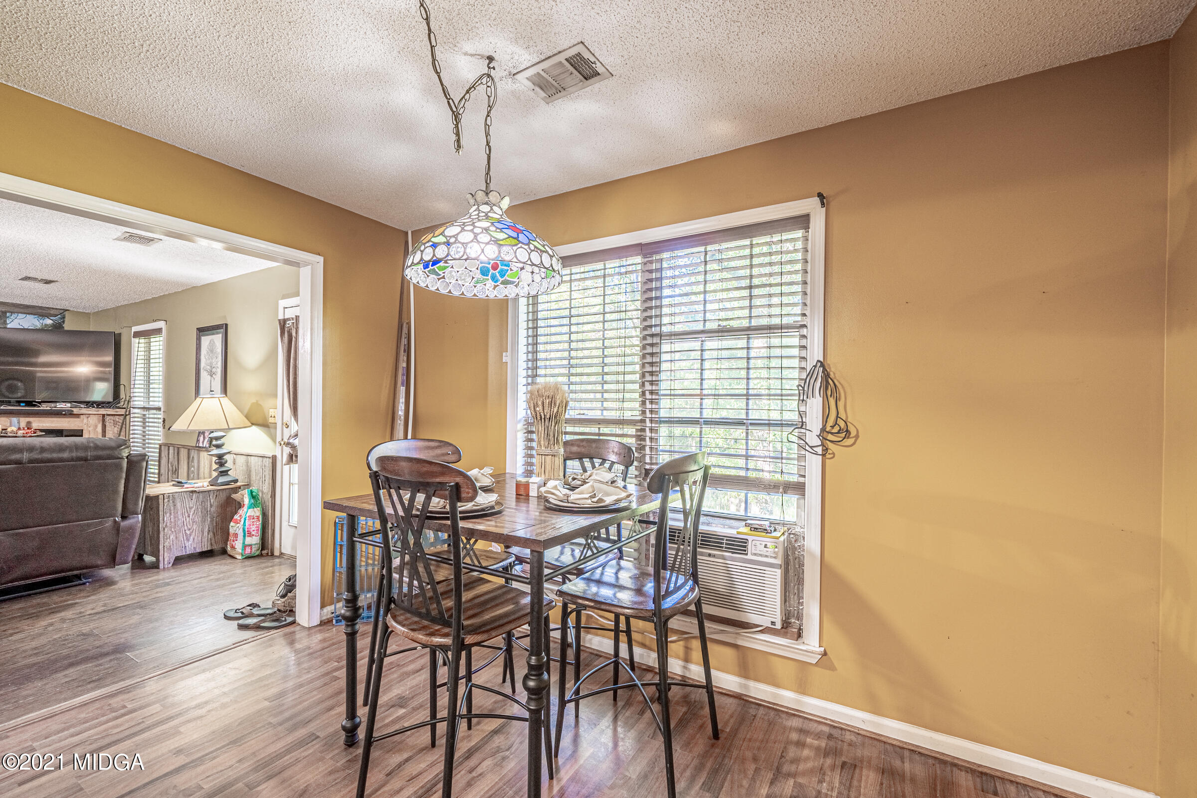 239 Plantation Road Gray, GA 31032 - Photo 10 of 28 a view of a dining room with furniture and wooden floor