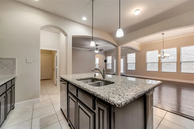 a kitchen with center island table and a sink