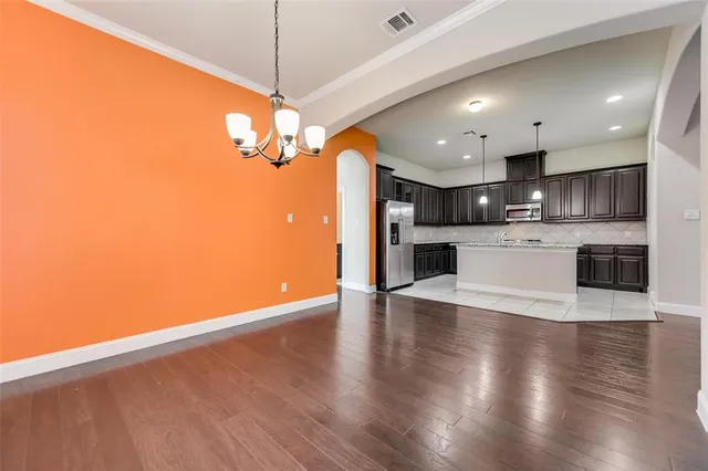 a view of a kitchen with a sink a refrigerator and a fireplace