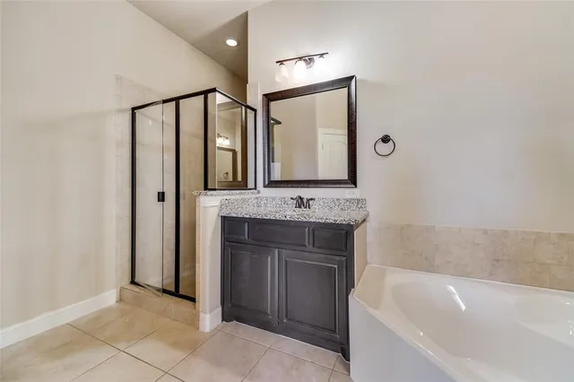 a bathroom with a bathtub sink double and mirror