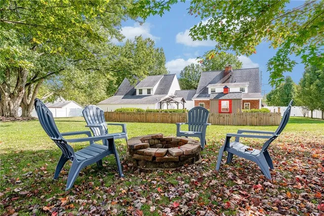 a swimming pool with outdoor seating and trees
