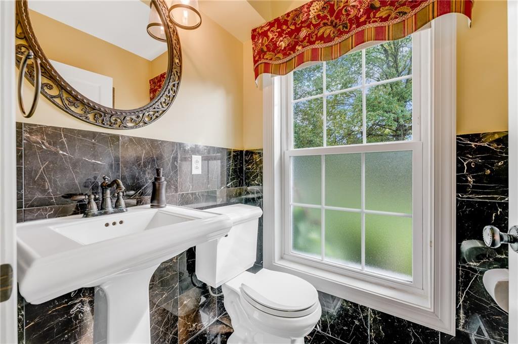 200 Balsinger Road Uniontown, PA 15401 - Photo 37 of 50 a bathroom with a sink a toilet and a mirror
