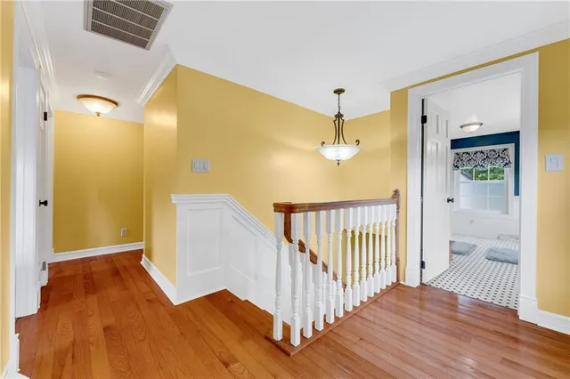 a bedroom with bed and wooden floor
