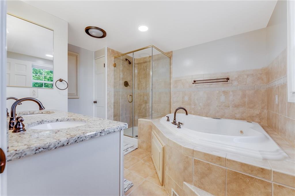 200 Balsinger Road Uniontown, PA 15401 - Photo 43 of 50 a bathroom with a bathtub sink and mirror