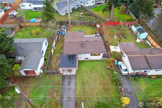 an aerial view of residential houses with outdoor space and street view
