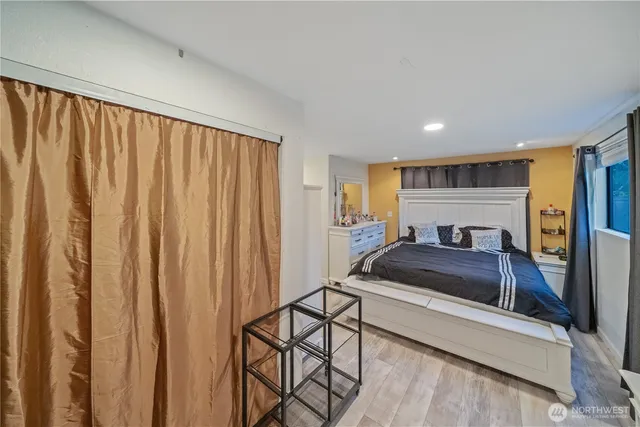 a bedroom with furniture and a window