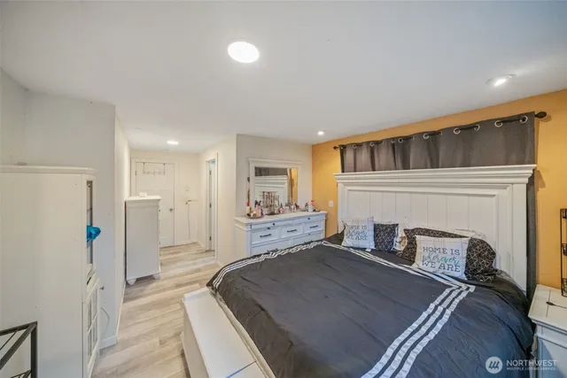 a spacious bedroom with a bed and a fireplace