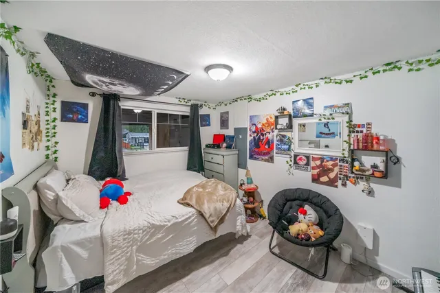 a bedroom with furniture and a wooden floor