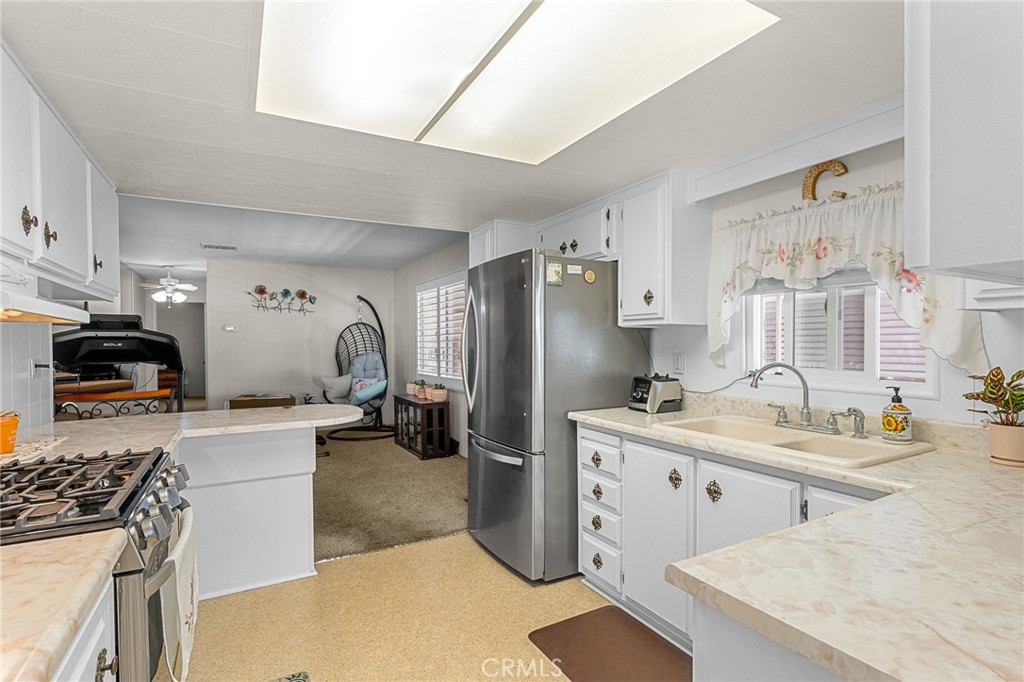 975 California Street, Unit 49 Calimesa, CA 92320 - Photo 12 of 31 a kitchen with a sink stove and refrigerator