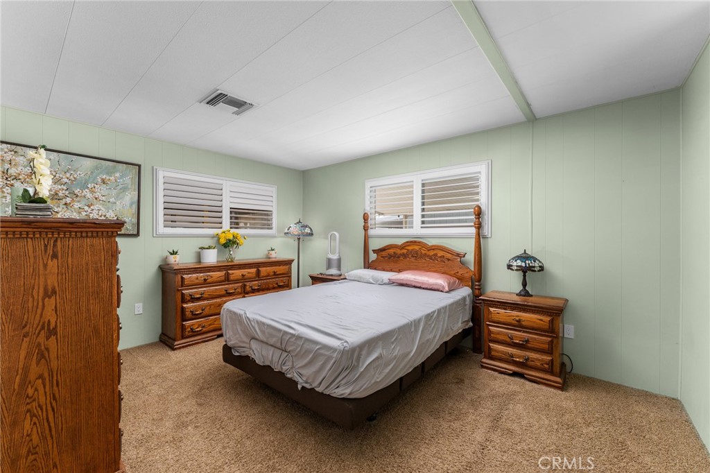 975 California Street, Unit 49 Calimesa, CA 92320 - Photo 16 of 31 a bedroom with a bed and dresser