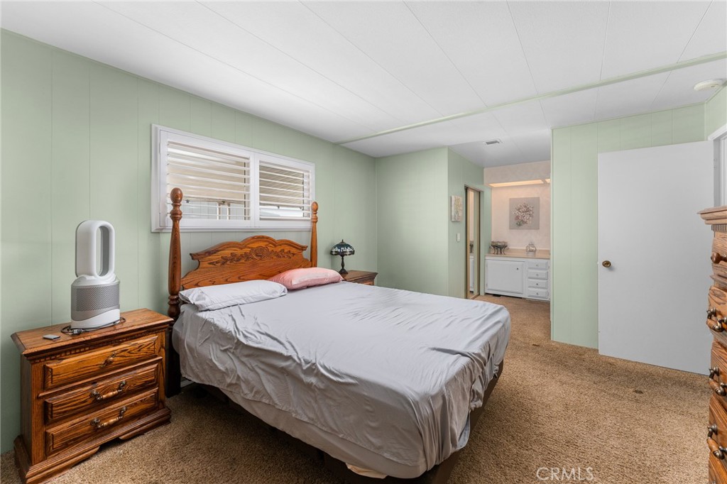 975 California Street, Unit 49 Calimesa, CA 92320 - Photo 17 of 31 a bedroom with a bed and wooden floor