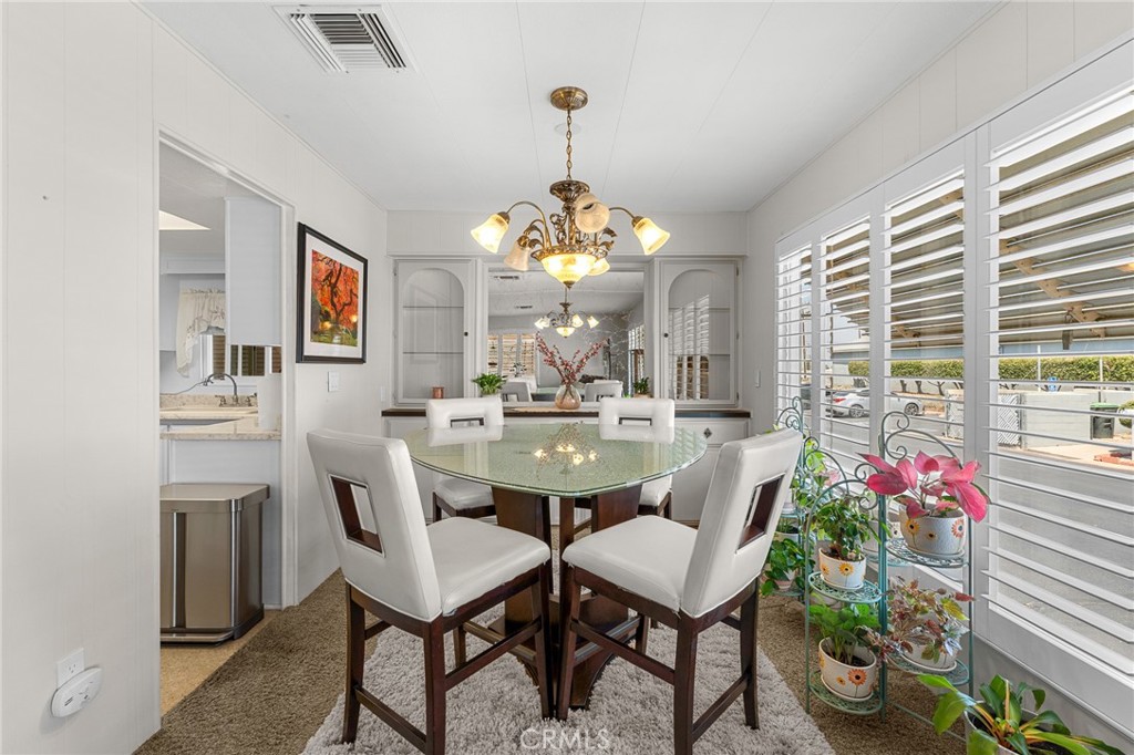 975 California Street, Unit 49 Calimesa, CA 92320 - Photo 7 of 31 a view of a dining room with furniture and a chandelier