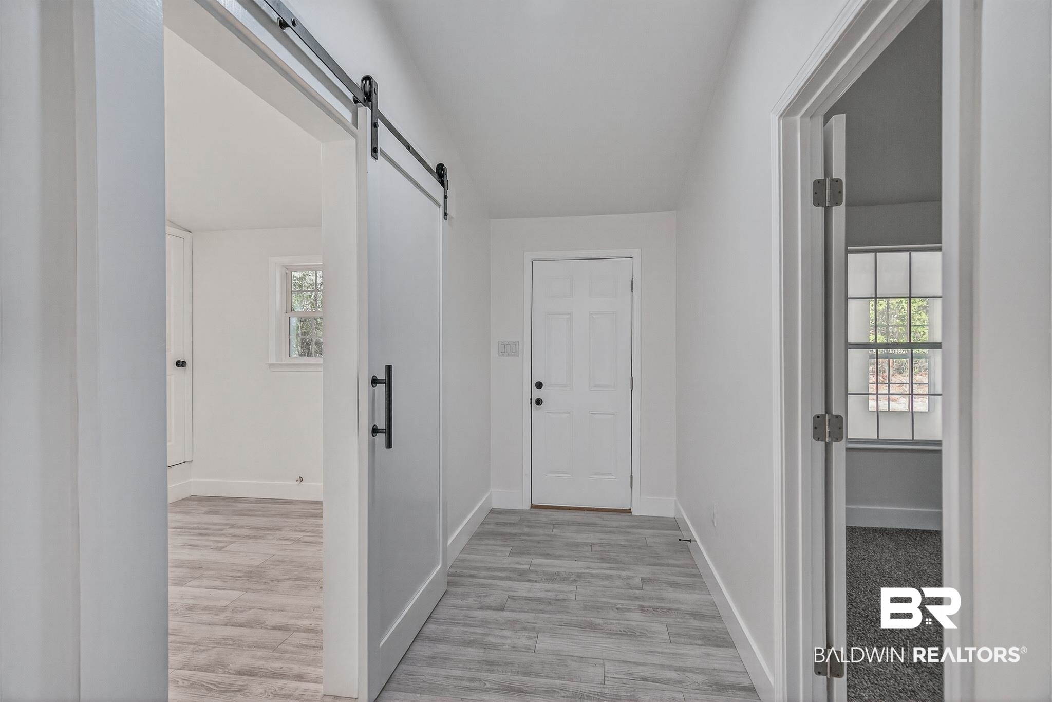 10650 Old Pascagoula Road Theodore, AL 36582 - Photo 52 of 77 Corridor featuring light wood-style floors and a barn door