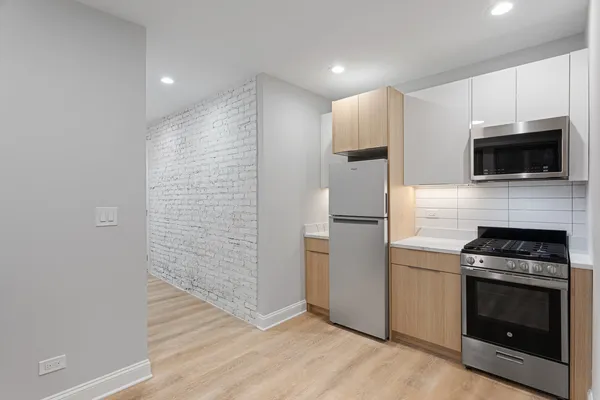 a kitchen with a refrigerator stove and microwave