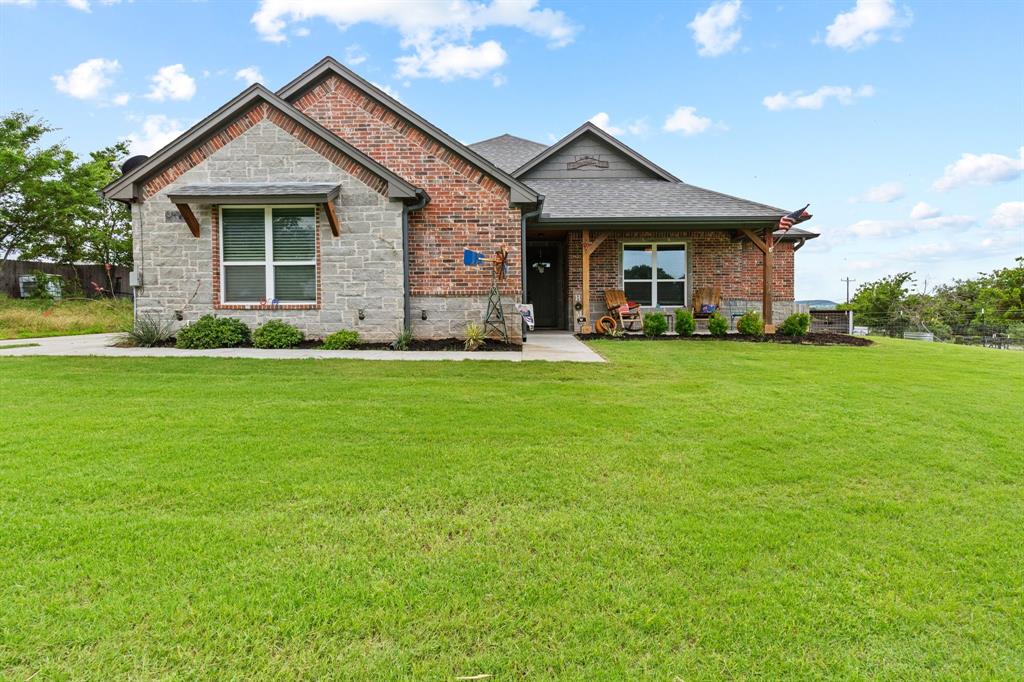 5530 Contrary Creek Road Granbury, TX 76048 - Photo 1 of 1 a front view of a house with a garden and porch