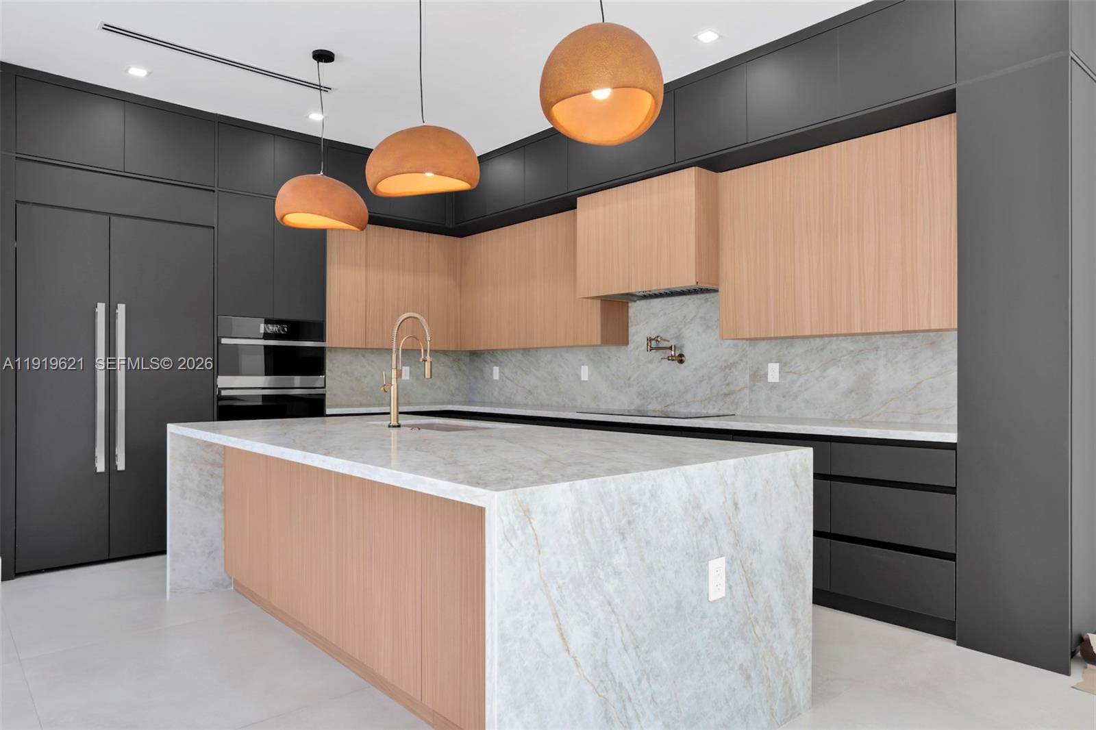 2324 Southwest 26th Street Miami, FL 33133 - Photo 3 of 14 a kitchen with stainless steel appliances granite countertop a sink a stove and a refrigerator