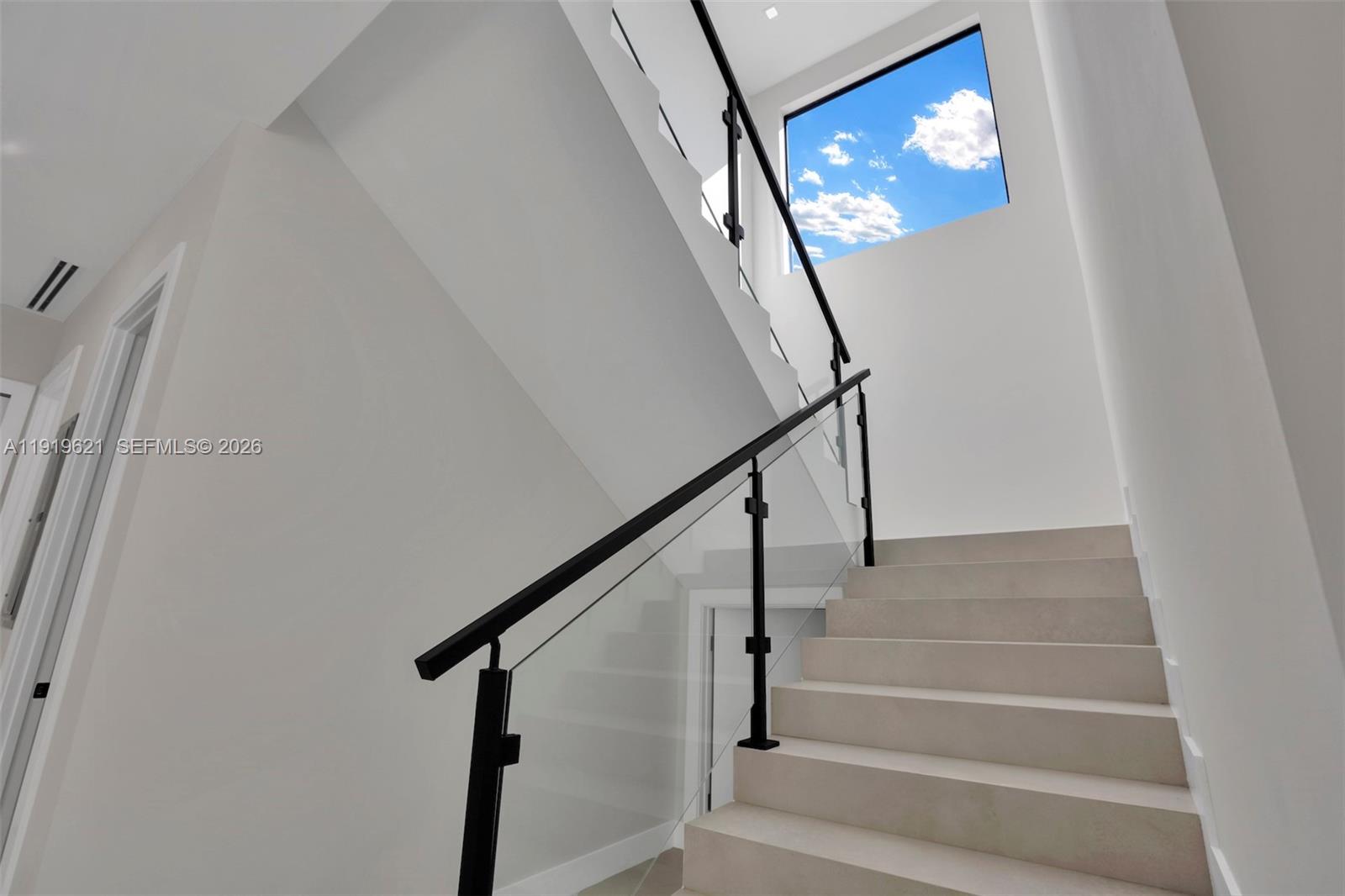 2324 Southwest 26th Street Miami, FL 33133 - Photo 5 of 14 a view of staircase with wooden floor and a rug