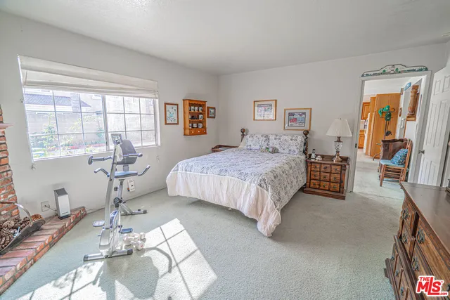 a bedroom with a bed couch and a window