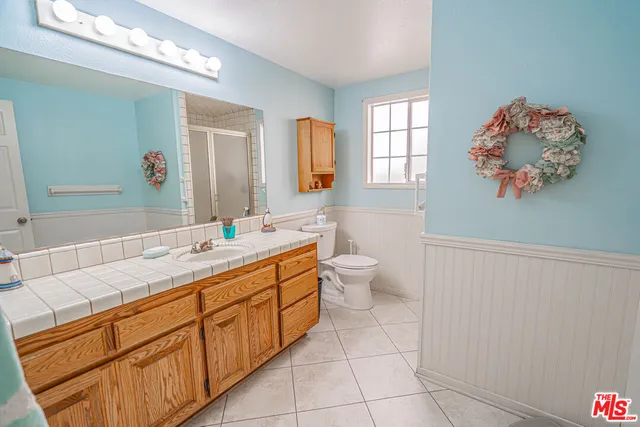 a spacious bathroom with a double vanity sink mirror and double