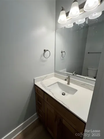 a bathroom with a sink vanity and a mirror