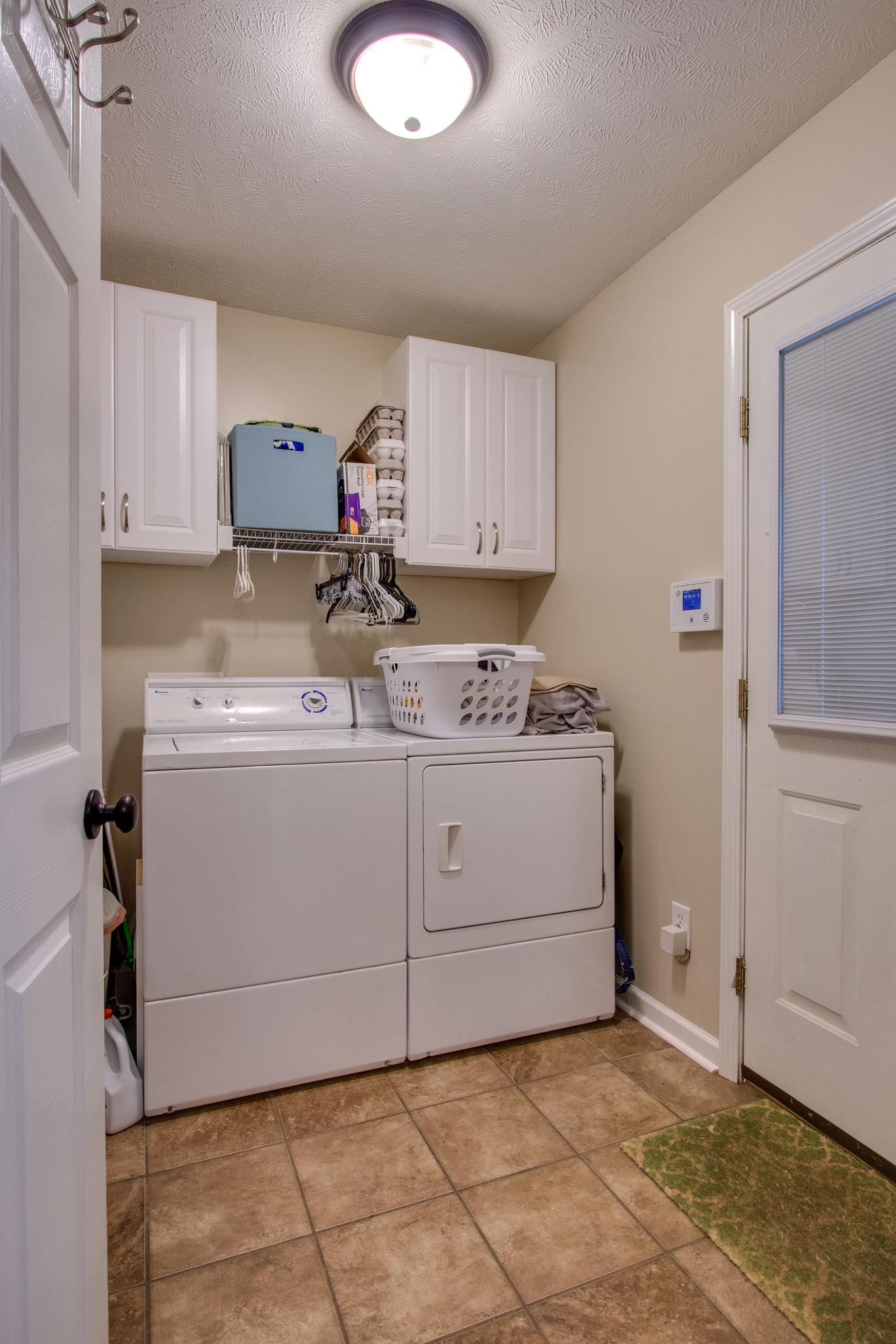 2010 Belotes Ferry Road Lebanon, TN 37087 - Photo 15 of 27 a utility room with cabinets washer and dryer