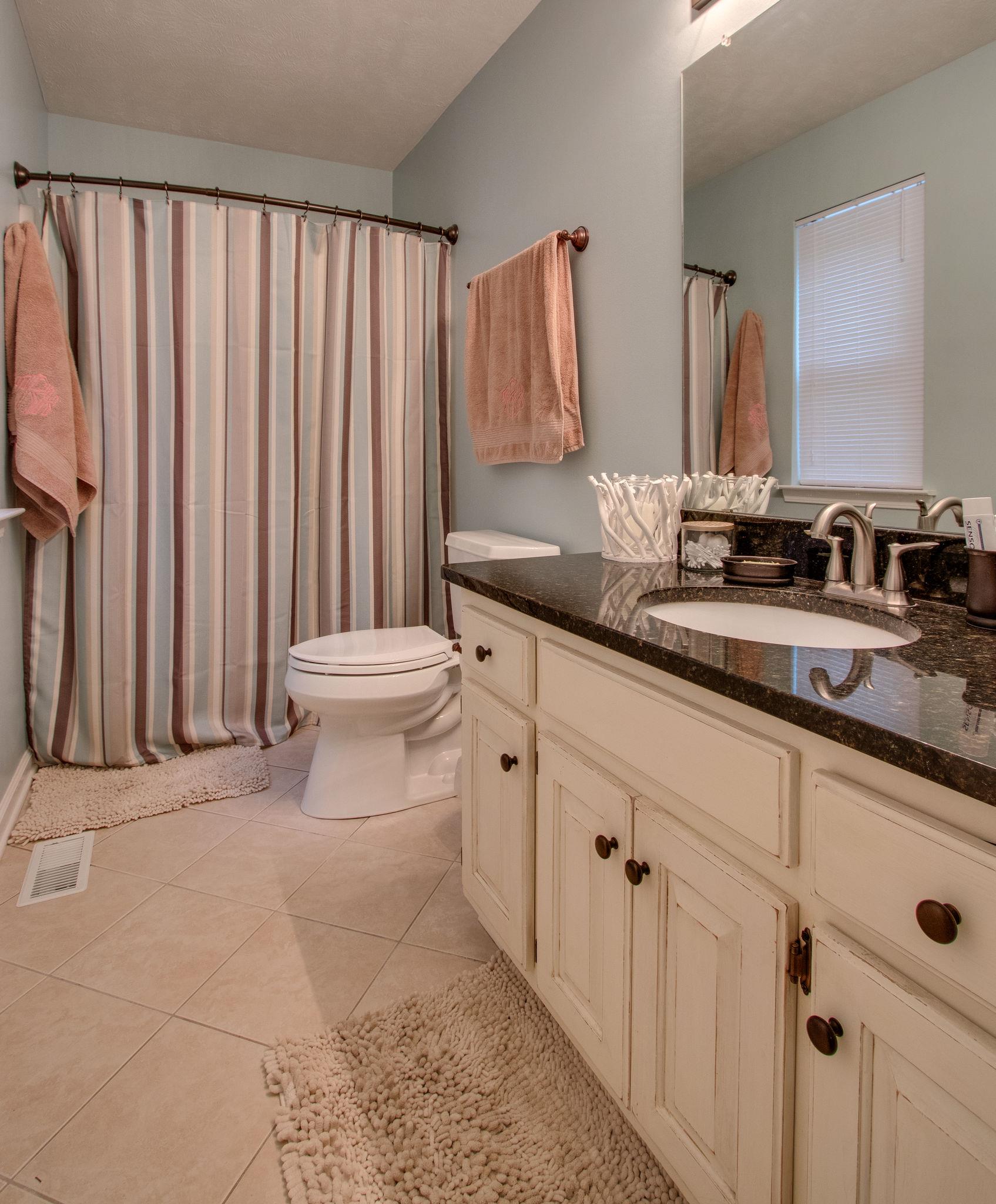 2010 Belotes Ferry Road Lebanon, TN 37087 - Photo 18 of 27 a bathroom with a double vanity sink and a mirror
