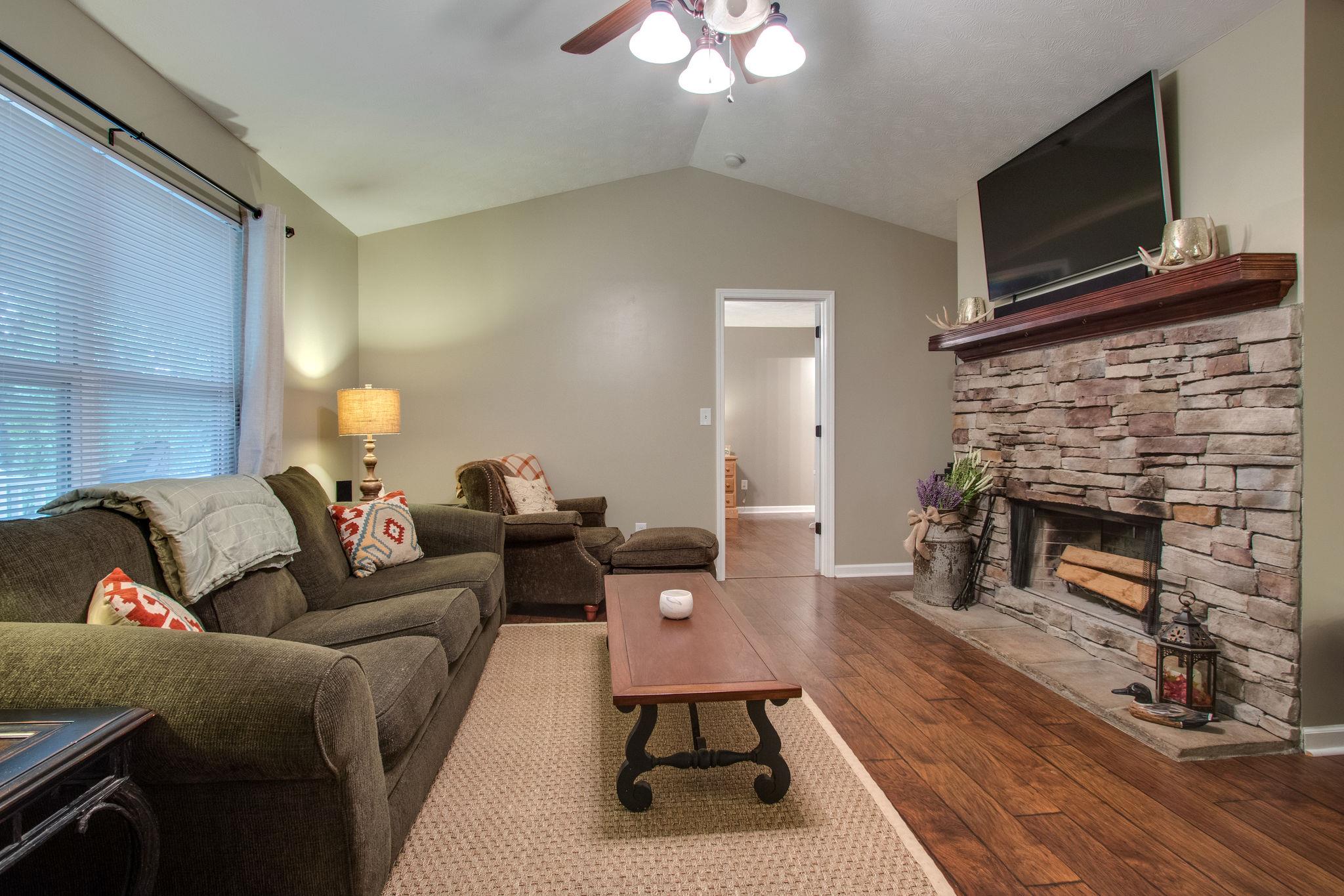 2010 Belotes Ferry Road Lebanon, TN 37087 - Photo 5 of 27 a living room with furniture a flat screen tv and a fireplace