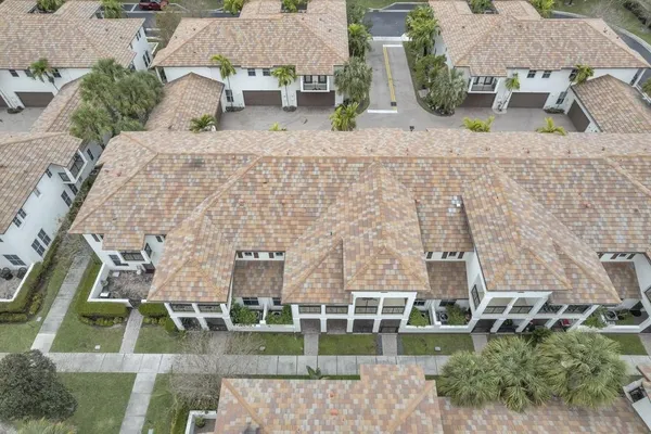 an aerial view of a house with a yard