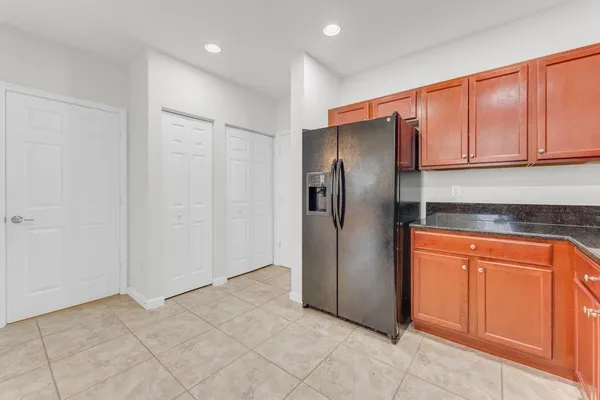 a metallic refrigerator freezer sitting in a kitchen