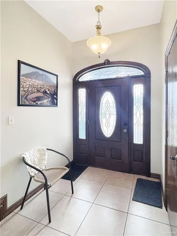 a living room with a mirror and a clock on wall