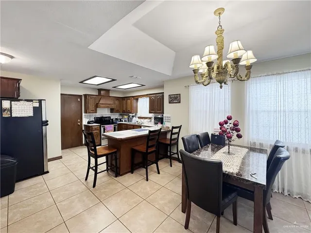 a view of a dining room with furniture and chandelier