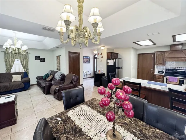 a bedroom with a bed mirror and chandelier